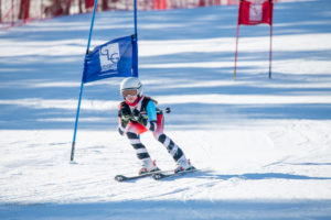 A DCWST Alpine Team member tucks in as she approaches the finish line.